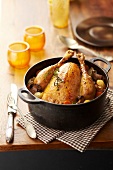 Roasted capon with mushrooms,carrots,onions and potatoes in a casserole dish