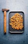 Caramelized mixed granola before crushing with a hammer