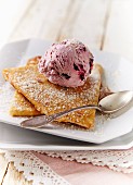 Pancakes with grated coconut and a scoop of cherry ice cream