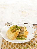 Fried salt cod with onions and thinly sliced green peppers