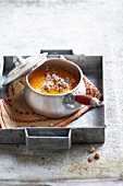 Pumpkin soup with crushed walnuts and almonds