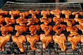 Grilled duck bills on a barbecue