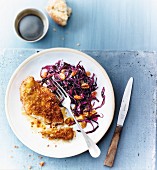 Chicken coated in crushed cornflakes, red cabbage with raisins