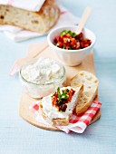 Ricotta and goat's cheese on sliced bread, roasted and sun-dried tomato salsa