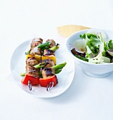 Pork and vegetable skewers,lettuce and apple salad