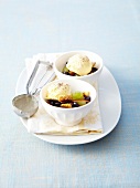 White and black fruit salad with walnuts,scoop of vanilla ice cream with maple syrup