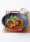 Stir-fried duck with red curry and carrots