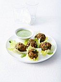 Lentil balls served in lettuce leaves with creamy mint sauce