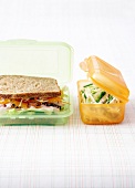 Chicken-pineapple brown bread sandwich and cripsy salad in linch boxes