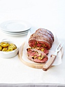 Rolled saddle of lamb stuffed with garlic and herbs