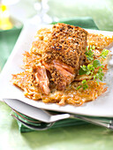 Salmon with gingerbread crust on hash browns