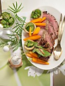 Roast leg of lamb with honey and spices served with steamed vegetables