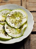Thin slices of lime with olive oil and herbs