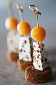 Gingerbread, blackcurrant peppery Petit Billy and melon ball appetizers on sticks