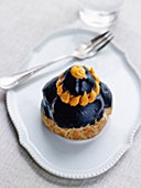Crab savoury Religieuse with squid ink frosting