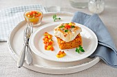 Piece of cod on a square timbale of saffron rice and virgin sauce