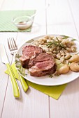 Slices of roast leg of lamb with rosemary and garlic