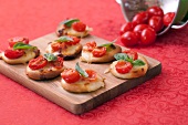 Mini pizzas with cherry tomatoes and basil