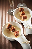 Amandine potato creamed soup with roasted snails and bacon