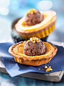 Orange tartlets topped with a scoop of chocolate ice cream