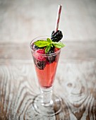 Waldfrucht-Cocktail in Glas mit Trinkhalm