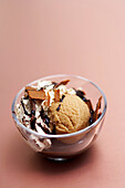 Coffee ice cream cup with chocolate sauce, whipped cream and gavotte chips