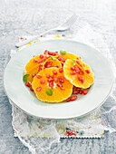 Orange carpaccio with pomegranate seeds