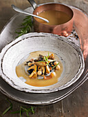 Meat broth with mushrooms, chickpeas and foie gras