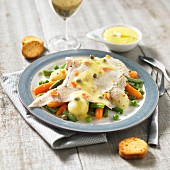 Skate wing in caper sauce and spring vegetables