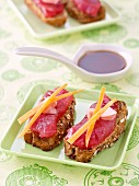 Raw tuna,ginger and carrot sticks on sliced granary bread