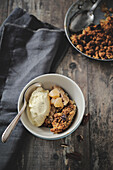 Portion of apple,pecan and maple syrup crumble with vanilla ice cream