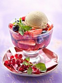 Summer fruit salad marinated with verbana,scoop of vanilla ice cream