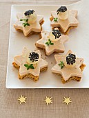 Gingerbread and foie gras stars topped with white grapes and black sesame seeds