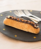 Chocolate Éclair topped with crushed pralines
