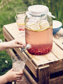 Large jug with tap of pomegranate seed lemonade