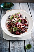 Wheat salad with herring, beetroot and red onions