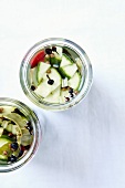 Preserved cucumbers with chilli and spices in preserving jars