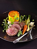 Saddle of lamb with thyme,carrot flan and sauteed vegetables
