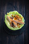 Marinated chicken breast,soft-boiled egg and anchovy salad served in a cabbage
