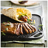 Grilled steak with chilli beans, avocado and tortillas