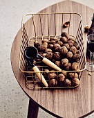Walnuts and a nutcracker in a metal basket