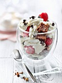 Brownies, raspberries and whipped cream in a glass