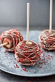 Chocolate and red sugar ball toffee apples