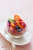 Chocolate cream with berry jelly and fruit salad in a glass