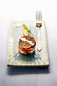 A buckwheat galette layered tartlet with fresh salmon and dill cream