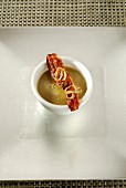 Curried lentil soup with crisp bacon and grilled onions