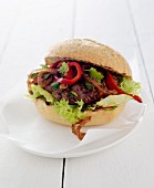 Mexican burger with onions and red peppers