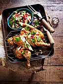 Spatchcock chicken served with bread salad with pomegranate seeds