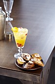 Orange liqueur cocktail with foie gras and two jams