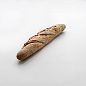 Linseed baguette on a white background